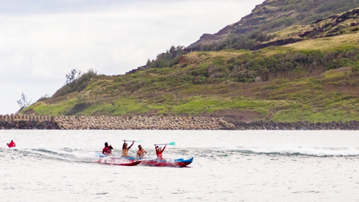 a group of people riding skis on a body of water