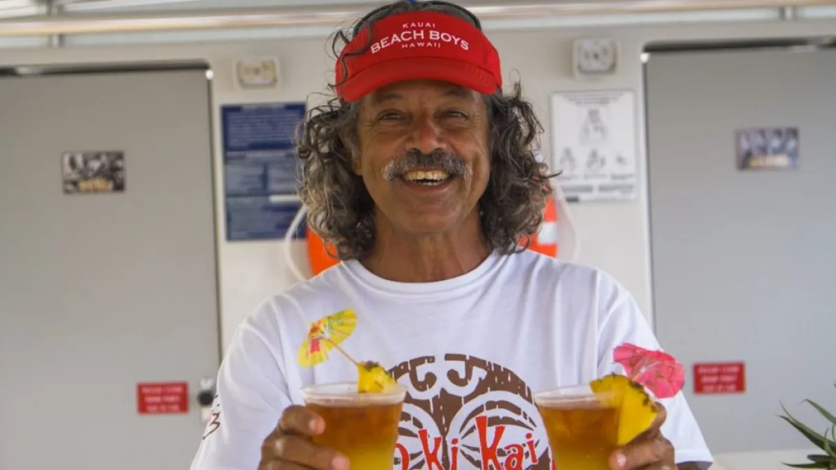 a person holding a glass of orange juice