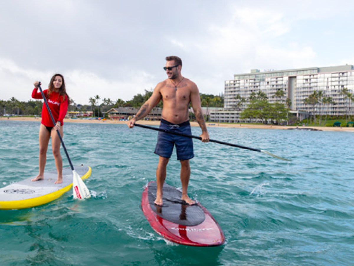 a man riding a surf board on a body of water
