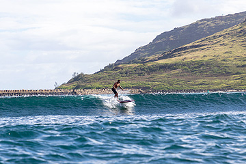 a man riding a wave on top of a body of water