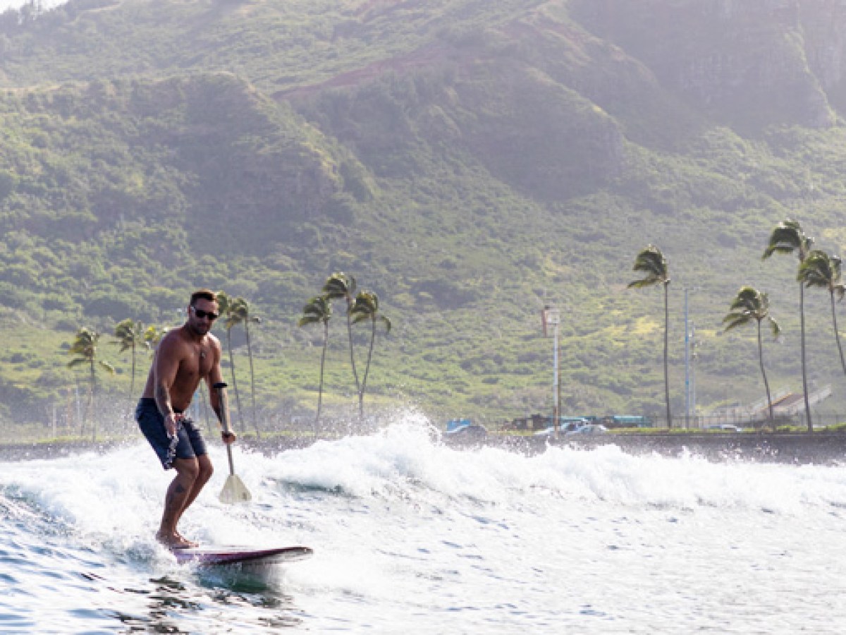 a man riding a wave on top of a mountain