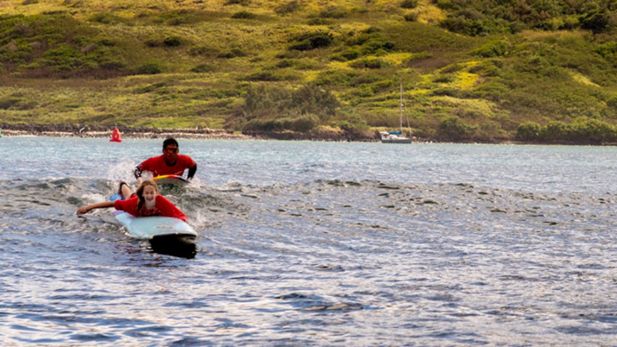a man riding a board on a body of water