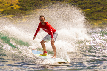 a man riding a wave on a surfboard in the water