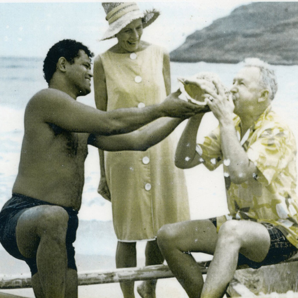 Percy Kinimaka helping Kauai Surf guests blow conch shell