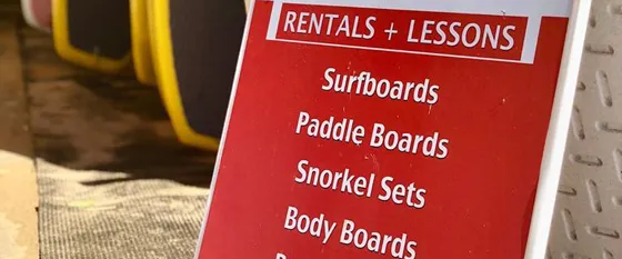 SURF lessons and beach rentals sign