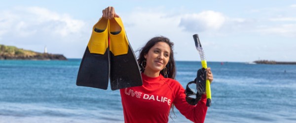 a person standing next to a body of water