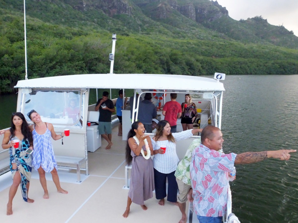 a group of people standing in front of a mountain