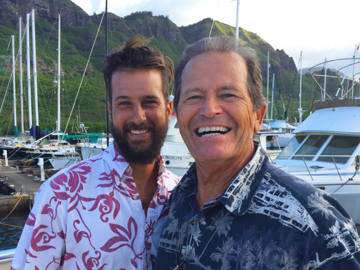 a person holding a fish on a boat posing for the camera