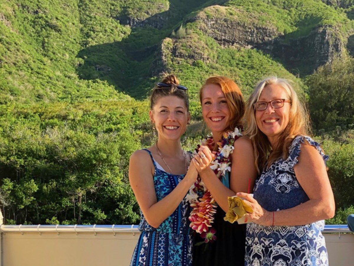 a woman standing in front of a mountain