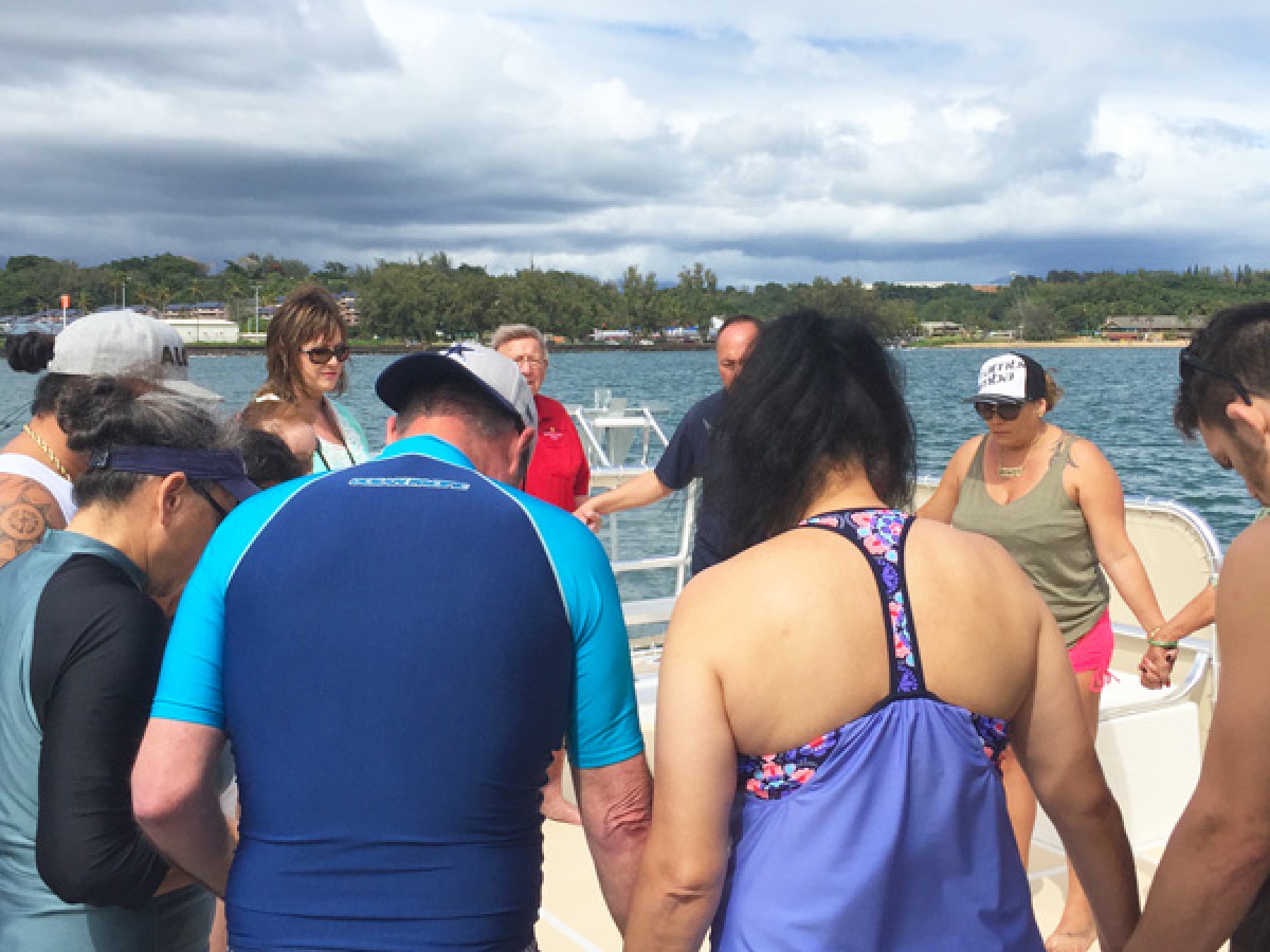 a group of people standing in the water