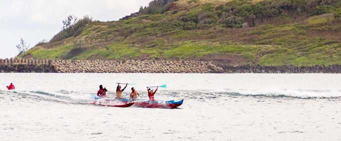 a group of people riding skis on a body of water